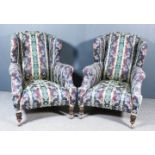 A Pair of Late Victorian Wingback Easy Chairs, upholstered in green and red leaf pattern brocade