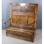 An 18th Century Panelled Oak High Back Settle, with open arms with rounded arm terminals and