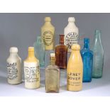 A Collection of Stoneware and Moulded Glass Advertising Bottles, and Other Clear and Coloured