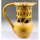 An English Lead-Glazed Puzzle Jug, 19th Century, of typical form with three drinking spouts, the
