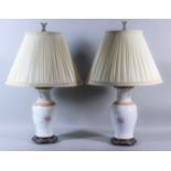 A Pair of Continental "Armorial" Porcelain Vases, mounted as electric table lamps, 12.5ins high, the