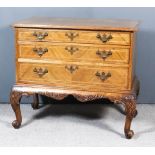 A 19th Century Walnut Low Chest of "18th Century" Design, by Gillows, the top quarter veneered and
