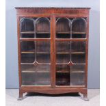 An Early 20th Century Mahogany Bookcase of "Georgian" Design, with gadroon edge to top, fitted three