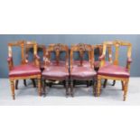 A Set of Six Late Victorian Walnut Dining Chairs, with angular backs carved with moulded arch, and a