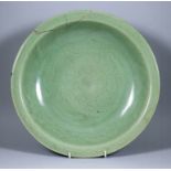 A Chinese Longquan Style Celadon Charger, Late Ming, incised with peony, 13.75ins (35cm) diameter