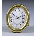 A Modern Cartier Lacquered Brass Oval Cased Travelling Alarm Clock, No. 890810758, the white dial