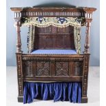 An Old Panelled Oak 4ft 6ins Full Tester Bedstead, of Elizabethan design, the headboard carved