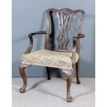 A George III Mahogany Armchair of "Chippendale" Design, the shaped back with carved leaf cappings,