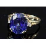 A Sapphire and Diamond Ring, Modern, in 14ct gold mount, set with a central oval sapphire,