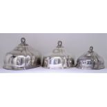 A Set of Three Victorian Plated Graduated Oval Meat Dish Covers, of slightly lobed form, the handles