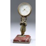 A French Desk Aneroid Barometer, 19th Century, supported on a gilt metal standing Chinese man, on