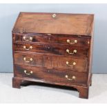 A George III Mahogany Bureau, the slope enclosing fitted interior with central cupboard, two