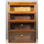 A 1920's Globe Wernicke Oak Four-Tier Sectional Bookcase, with glazed rising fronts, 34ins wide x