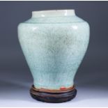 A Chinese Celadon Jar, the body and shoulder with carved decoration, 9.5ins (24.2cm) high, with