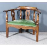 An 18th Century Mahogany Low Corner Chair of Large Proportions, the horseshoe pattern back with