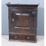 An 18th Century Oak Hanging Wall Cupboard, with moulded cornice, the green painted interior fitted