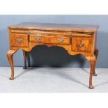 A Walnut Lowboy of "18th Century" Design, the quarter veneered top inlaid with banding and
