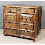 A 17th Century Panelled Oak Chest, with moulded edge to top, fitted four long drawers with twin