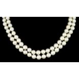 A Good 685mm Two-Strand of Cultured Pearls, with 18k gold oval clasp set with 57 small diamonds