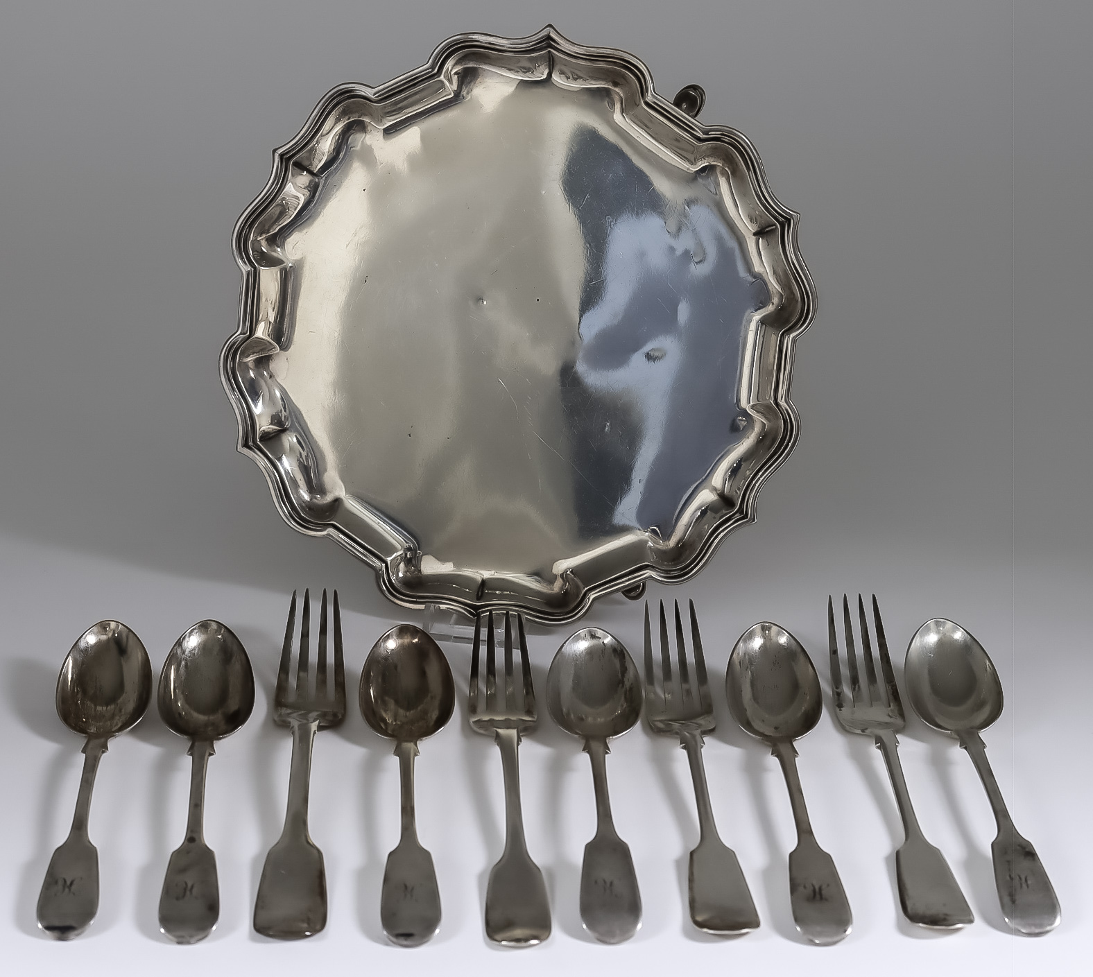 An Edward VII Silver Circular Salver, Six Victorian Silver Fiddle Pattern Dessert Spoons, and Four