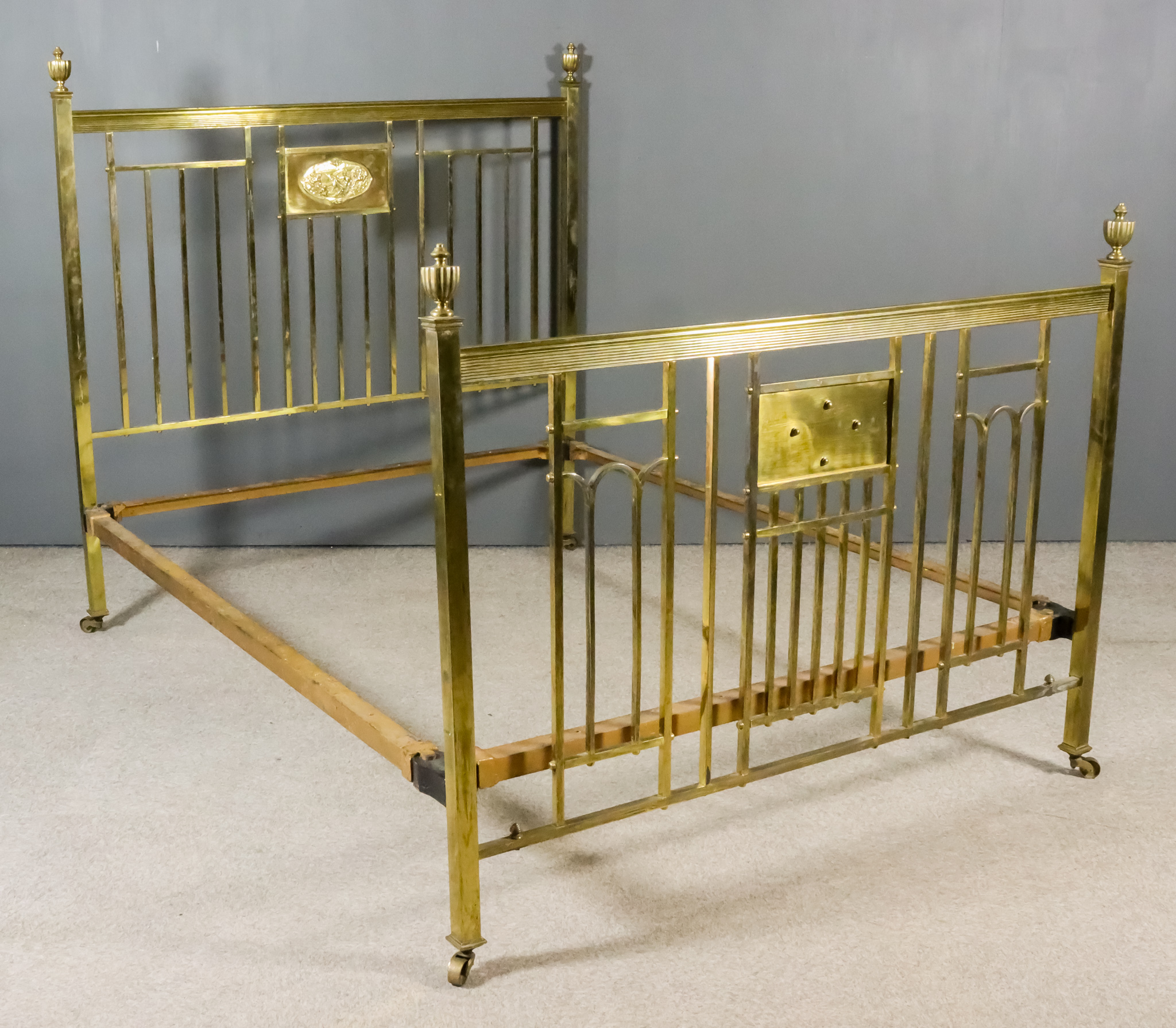 A Late Victorian/Early 20th Century Brass 5ft Bedstead, the square uprights with reeded urn finials,