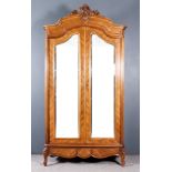 A Late 19th Century French Walnut Armoire, the shaped and moulded cornice with carved leaf, C- and