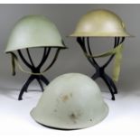 A World War II Steel "Turtle" Helmet, three other "turtle" helmets, a World War II Belgian steel