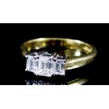 A Three Stone Diamond Ring, Modern, in 18ct gold mount, set with three baguette cut diamonds,