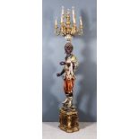 A 20th Century Italian Painted and Gilt Wood Blackamoor Candelabra, with nine leaf capped scroll