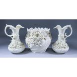 A Pair of Belleek Porcelain Ewers, 2nd Mark, 1891-1926, modelled with floral sprays, 9.25ins high,