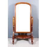 A Victorian Mahogany Framed Cheval Mirror, with arched top, inset with plain mirror plate, 39ins x