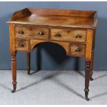 An Early 19th Century Mahogany Kneehole Writing Table, the galleried top with a central adjustable