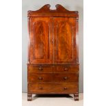 A George IV Gentleman's Mahogany Wardrobe, the upper part inlaid with ebonised stringings, with