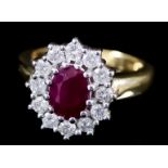 A Ruby and Diamond Ring, Modern, in 18ct gold mount, the centre collet set with a ruby,