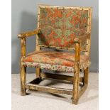 An Old Oak Rectangular Backed Armchair of "17th Century" Design, the seat and back upholstered in