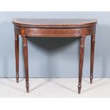 A George III Mahogany D-Shaped Card Table, the top veneered in "Plum Pudding" mahogany within wide