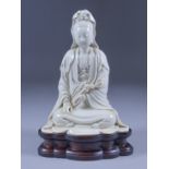 A Chinese Blanc de Chine Figure of the Seated Guan Yin, with He Chaozong mark within a double