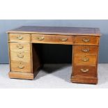 A Late Victorian Walnut Kneehole Desk, with red tooled leather inset to top, fitted three frieze