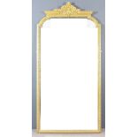 A Late 19th Century French Gilt Framed Overmantel Mirror of "Neo Classical" Design, the shaped top