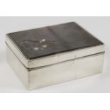 A Japanese Silver and Shakudo Rectangular Box and Cover, the bronze lid carved and inlaid in