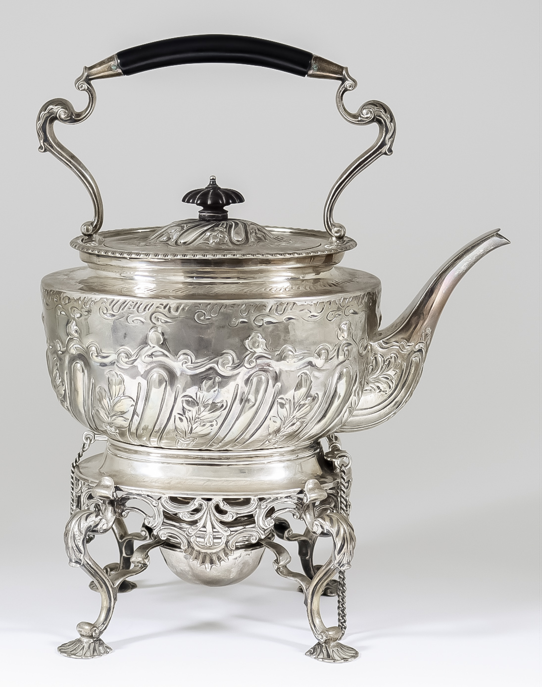 A Silvery Metal Oval Tea Kettle on Silver Stand, the kettle with ebonised handle on leaf capped