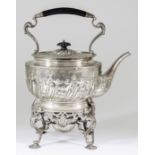A Silvery Metal Oval Tea Kettle on Silver Stand, the kettle with ebonised handle on leaf capped