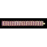 A Diamond and Ruby Bracelet, 20th Century, in yellow metal mount, set with baguette cut rubies,