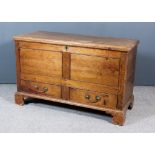 An 18th Century Pine Mule Chest, the plain top with moulded edge with twin flush panelled front