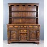 A Panelled Oak Dresser of "18th Century" Design, the upper part with moulded cornice above shaped