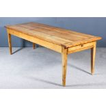 A 19th Century French Fruitwood Kitchen Table, with cleated plank top, fitted one drawer to one end,