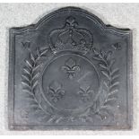 A French Cast Iron Fireback, cast with crowned circular panel containing three fleur-de-lis within