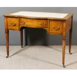 An Edwardian Mahogany Bow and Breakfront Writing Table, inlaid with stringings and crossbanded in
