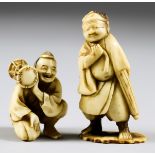 A Japanese Carved Ivory Netsuke of a Figure Holding a Drum, 19th Century, 1.5ins (3.8cm) high, and