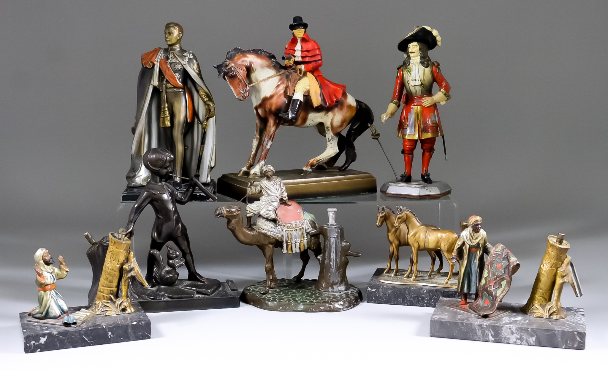 Eight Painted Metal Figural Table Lighters, Early 20th Century, including masked highway man, 9ins